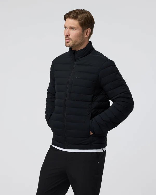 Man wearing a Vuori - Steadfast Insulated Full Zip Jacket  on a light gray background